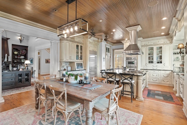 dining area with ornate columns, a ceiling fan, crown molding, and wooden ceiling