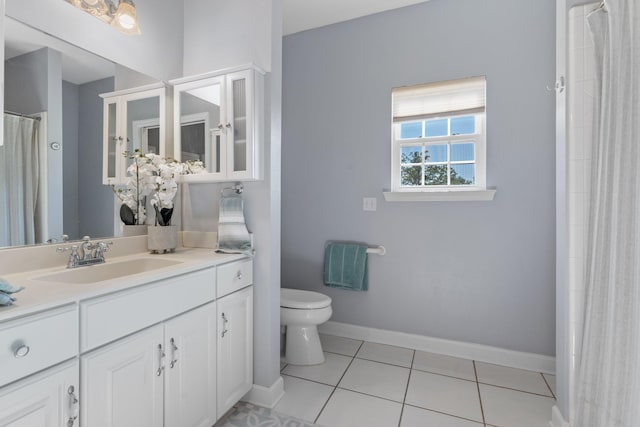 full bath featuring baseboards, toilet, tile patterned flooring, and vanity