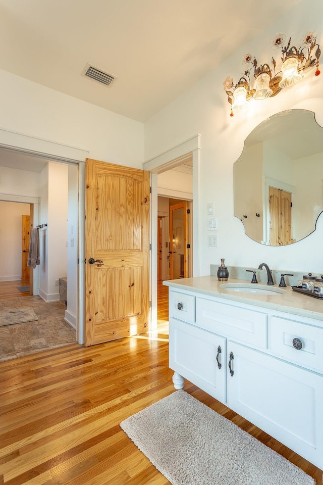 bathroom with hardwood / wood-style floors and vanity