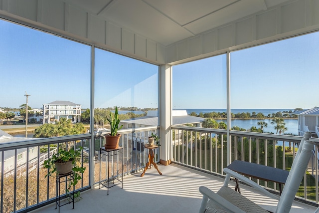 sunroom / solarium with a water view and a wealth of natural light