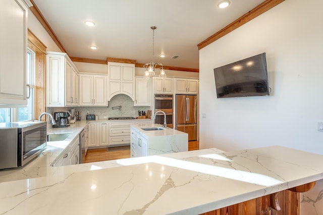 kitchen featuring stainless steel appliances, a kitchen island, tasteful backsplash, and sink