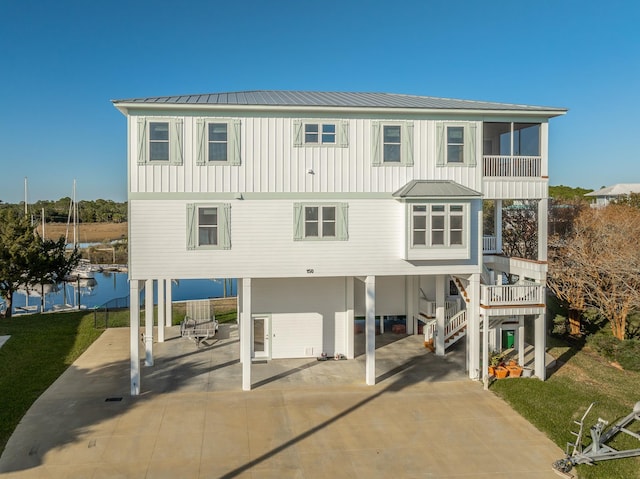 view of front facade featuring a water view and a carport