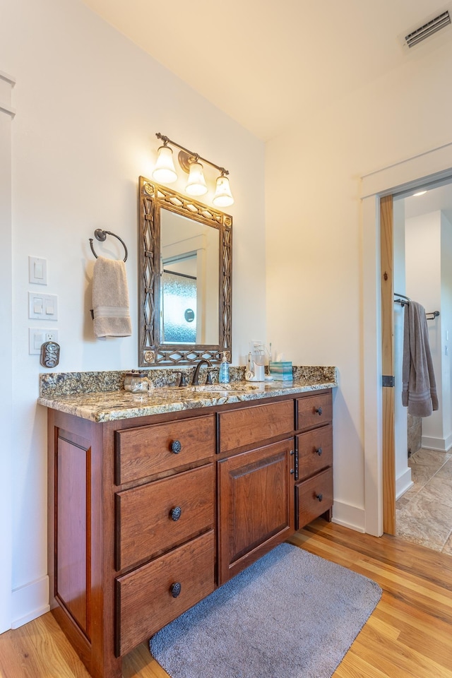 bathroom featuring vanity and wood-type flooring