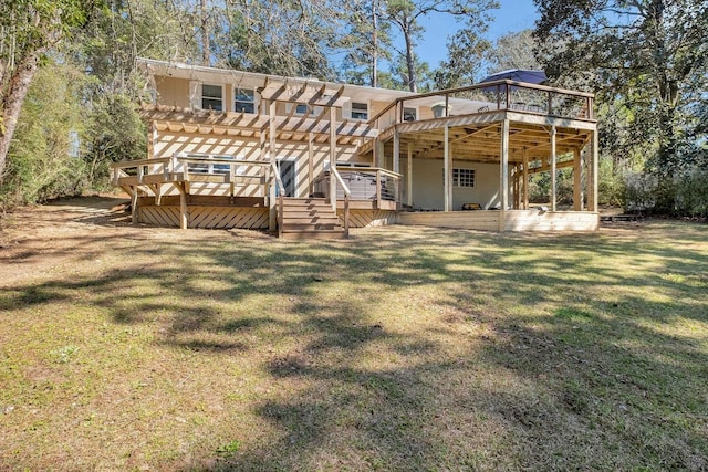 back of house featuring a pergola, a lawn, and a deck