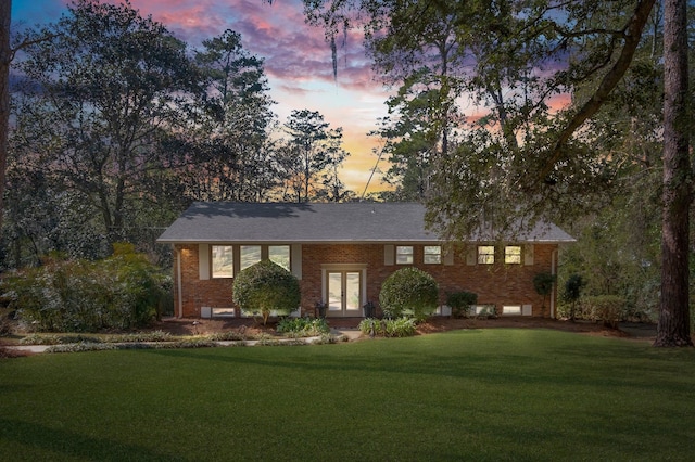 ranch-style home featuring a yard