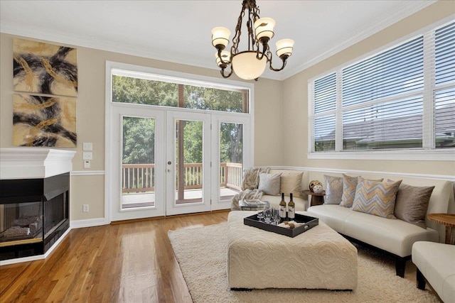 7502 Refuge Rd, Tallahassee, FL 32312 - living area with a chandelier, wood finished floors, ornamental molding, french doors, and a multi sided fireplace