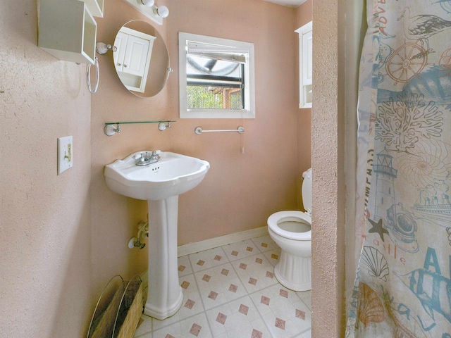 18722 Key Deer Ct, Keaton Beach, FL 32348 - bathroom featuring toilet, tile patterned flooring, and baseboards