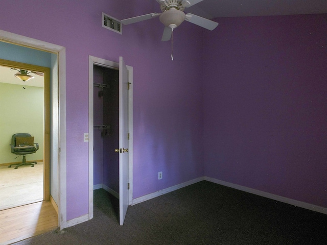 18722 Key Deer Ct, Keaton Beach, FL 32348 - unfurnished bedroom featuring a closet, carpet flooring, a spacious closet, baseboards, and ceiling fan
