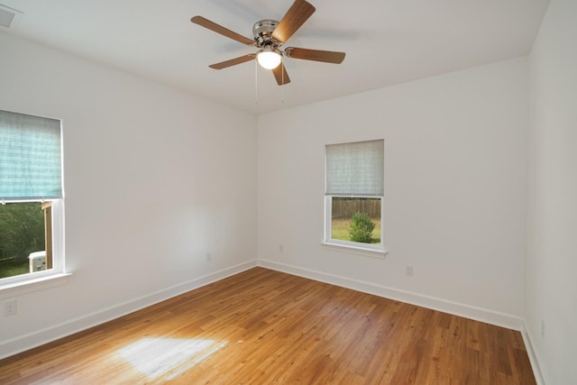 empty room featuring ceiling fan and hardwood / wood-style flooring