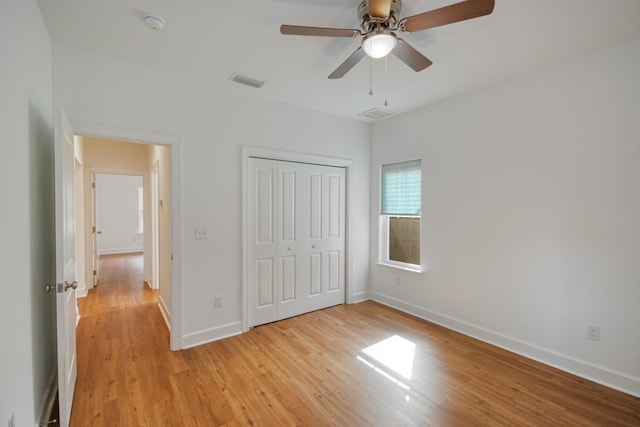 unfurnished bedroom featuring a closet, ceiling fan, and light hardwood / wood-style flooring