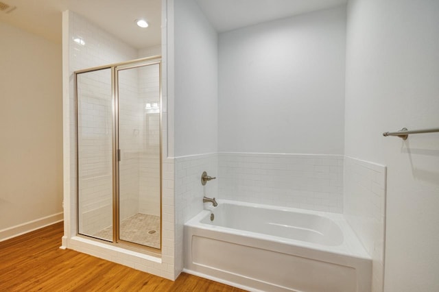 bathroom with wood-type flooring and separate shower and tub