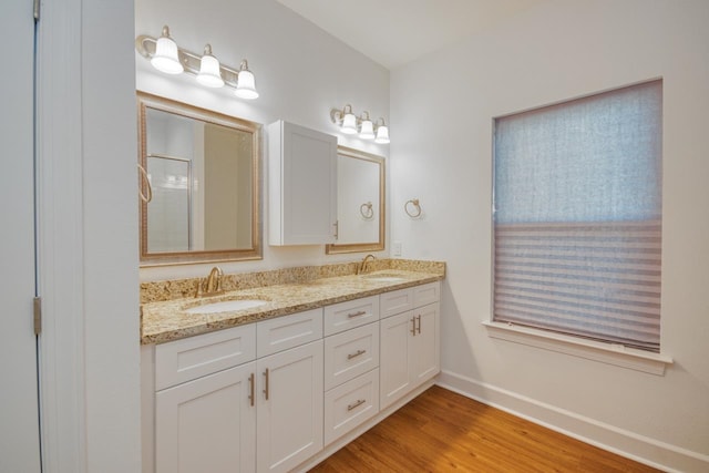 bathroom featuring hardwood / wood-style flooring, vanity, and a shower with door