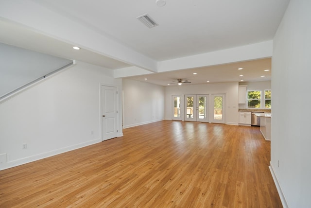 unfurnished living room featuring light hardwood / wood-style floors and ceiling fan