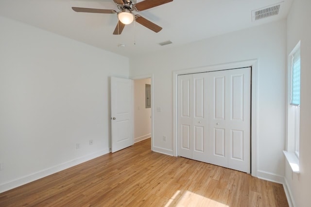 unfurnished bedroom with ceiling fan, light hardwood / wood-style floors, and a closet