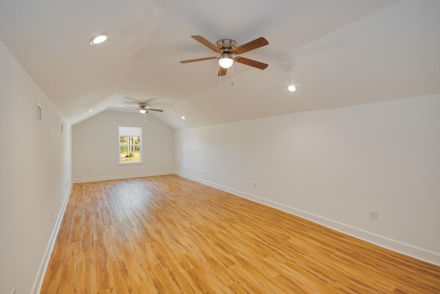 additional living space featuring light hardwood / wood-style flooring, ceiling fan, and lofted ceiling