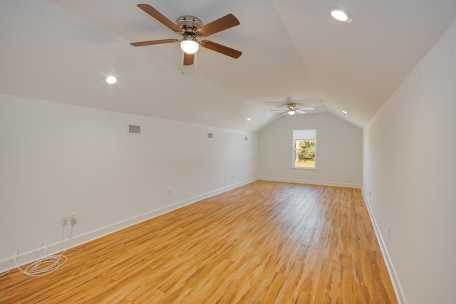 additional living space featuring light wood-type flooring, vaulted ceiling, and ceiling fan