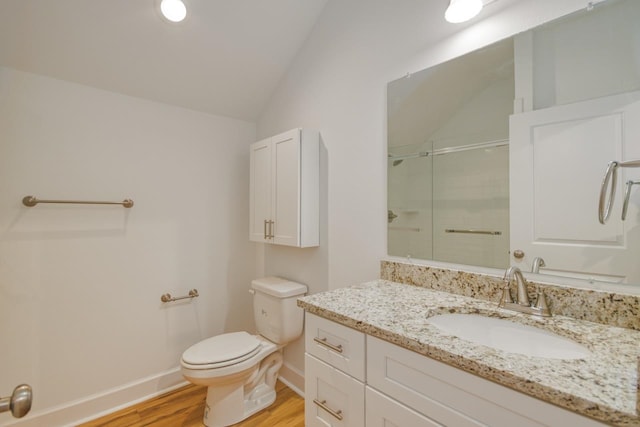 bathroom featuring vanity, a shower with door, wood-type flooring, toilet, and lofted ceiling