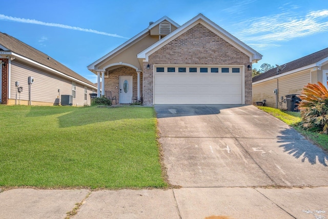 view of front of property with a garage, cooling unit, and a front lawn