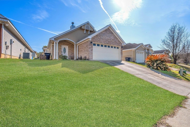 view of front of house featuring a front lawn, cooling unit, and a garage