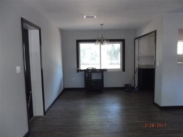312 W Margurite St, Perry, FL 32347 - unfurnished dining area featuring dark wood-style flooring and a chandelier