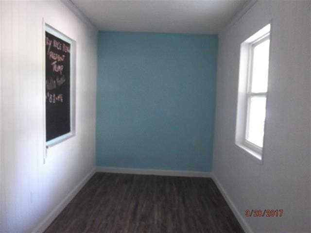 312 W Margurite St, Perry, FL 32347 - spare room featuring dark wood finished floors and baseboards