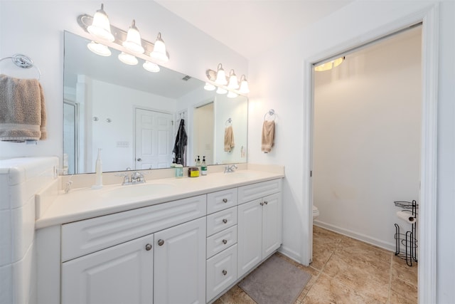 1842 Acorn Ridge Trl, Tallahassee, FL 32312 - full bath with double vanity, toilet, a stall shower, and baseboards