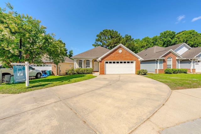 1842 Acorn Ridge Trl, Tallahassee, FL 32312 - view of front facade with concrete driveway, brick siding, an attached garage, and a front lawn