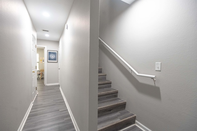 stairs featuring wood-type flooring