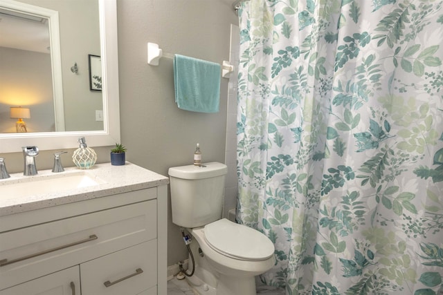 bathroom with vanity, toilet, and a shower with shower curtain