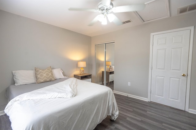 bedroom featuring dark wood-type flooring, a closet, and ceiling fan