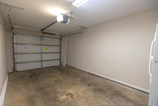 garage with a garage door opener and white refrigerator