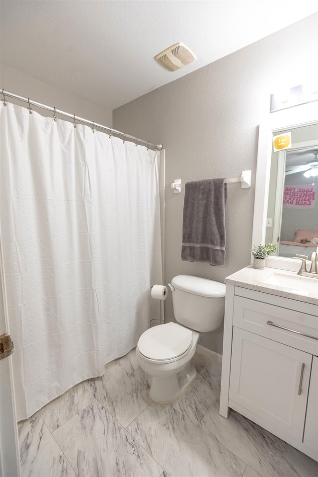 bathroom featuring vanity and toilet