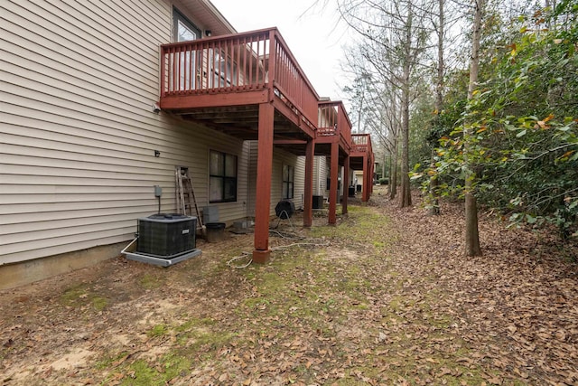 view of yard with central air condition unit and a deck