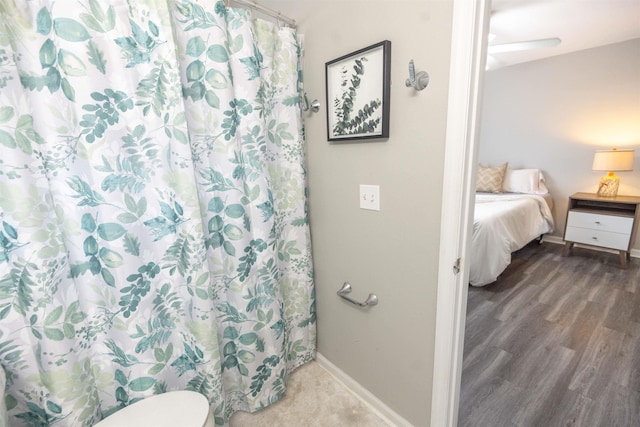 bathroom featuring hardwood / wood-style flooring and a shower with shower curtain