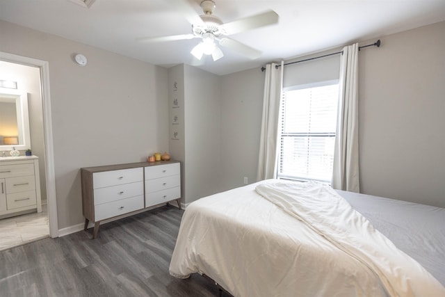 bedroom featuring ensuite bathroom, dark hardwood / wood-style floors, and ceiling fan