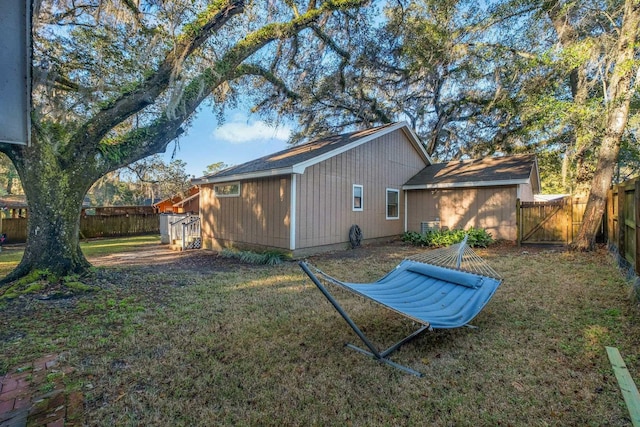 rear view of property with a yard