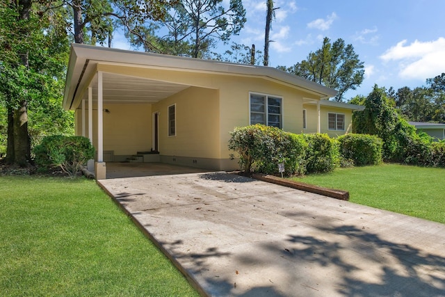 view of front of house with a front yard and a carport