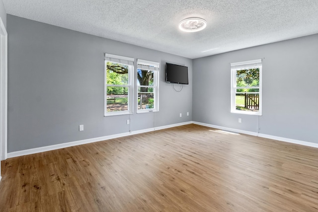 11124 Bexhill Ln, Tallahassee, FL 32317 - spare room with a textured ceiling, light wood finished floors, and baseboards
