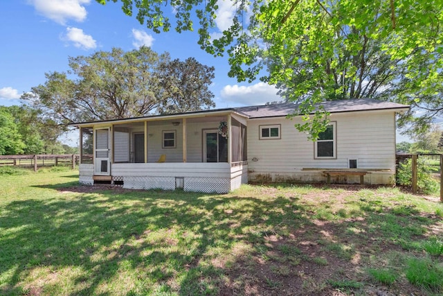 11124 Bexhill Ln, Tallahassee, FL 32317 - back of property featuring fence, a sunroom, and a lawn