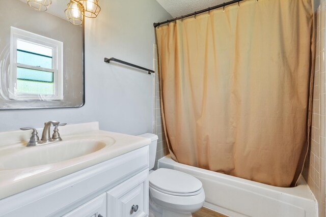 11124 Bexhill Ln, Tallahassee, FL 32317 - full bath with toilet, a textured ceiling, vanity, and shower / bath combination with curtain