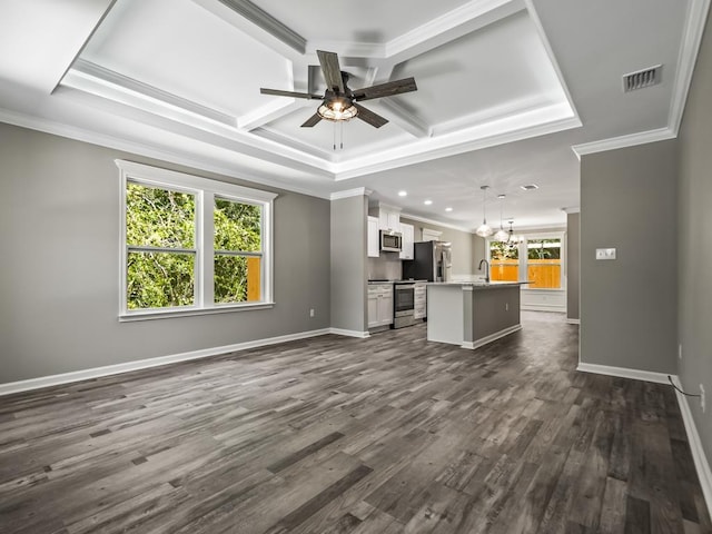 unfurnished living room featuring coffered ceiling, ceiling fan with notable chandelier, a wealth of natural light, and dark wood-type flooring