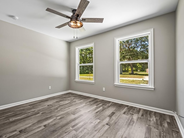 unfurnished room with hardwood / wood-style floors and ceiling fan