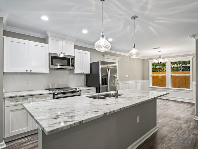 kitchen featuring sink, crown molding, appliances with stainless steel finishes, hanging light fixtures, and white cabinets