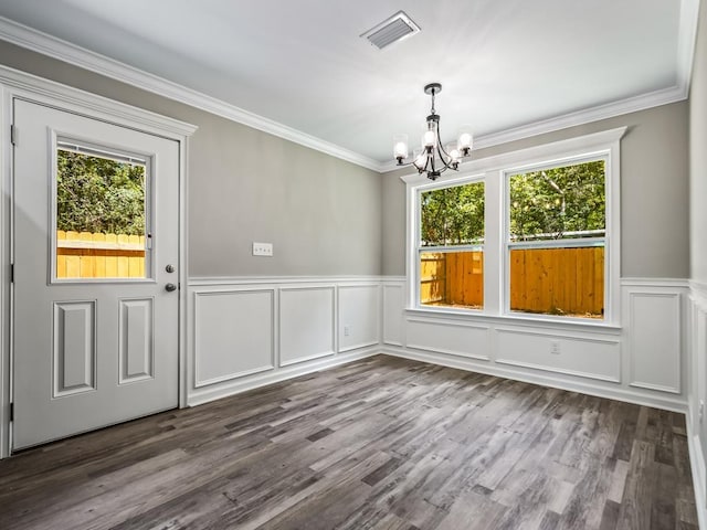 unfurnished dining area featuring an inviting chandelier, hardwood / wood-style flooring, and ornamental molding