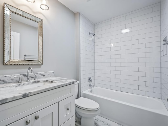 full bathroom featuring vanity, toilet, and tiled shower / bath