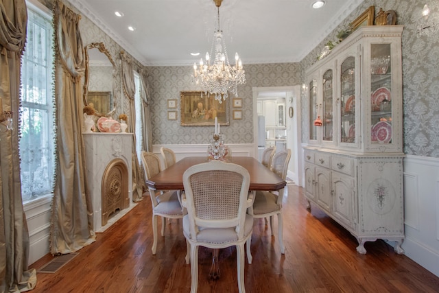 2460 Canopy Ln, Perry, FL 32347 - dining room with wallpapered walls, a chandelier, a decorative wall, wood finished floors, and wainscoting