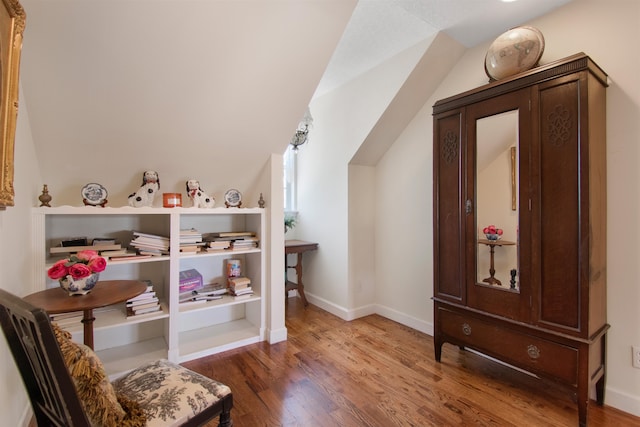 2460 Canopy Ln, Perry, FL 32347 - living area with wood finished floors, vaulted ceiling, and baseboards