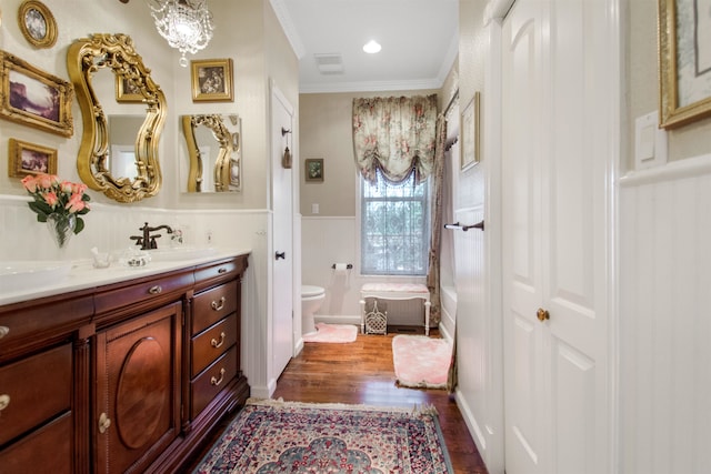 2460 Canopy Ln, Perry, FL 32347 - bathroom featuring wood finished floors, ornamental molding, a wainscoted wall, vanity, and toilet