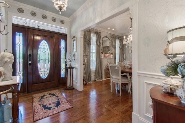 2460 Canopy Ln, Perry, FL 32347 - entrance foyer featuring a chandelier, ornamental molding, wallpapered walls, a wainscoted wall, and wood finished floors