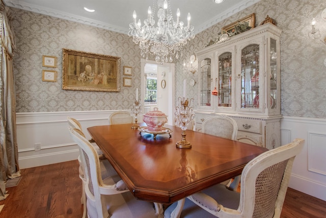 2460 Canopy Ln, Perry, FL 32347 - dining area featuring dark wood finished floors, a chandelier, wainscoting, ornamental molding, and wallpapered walls